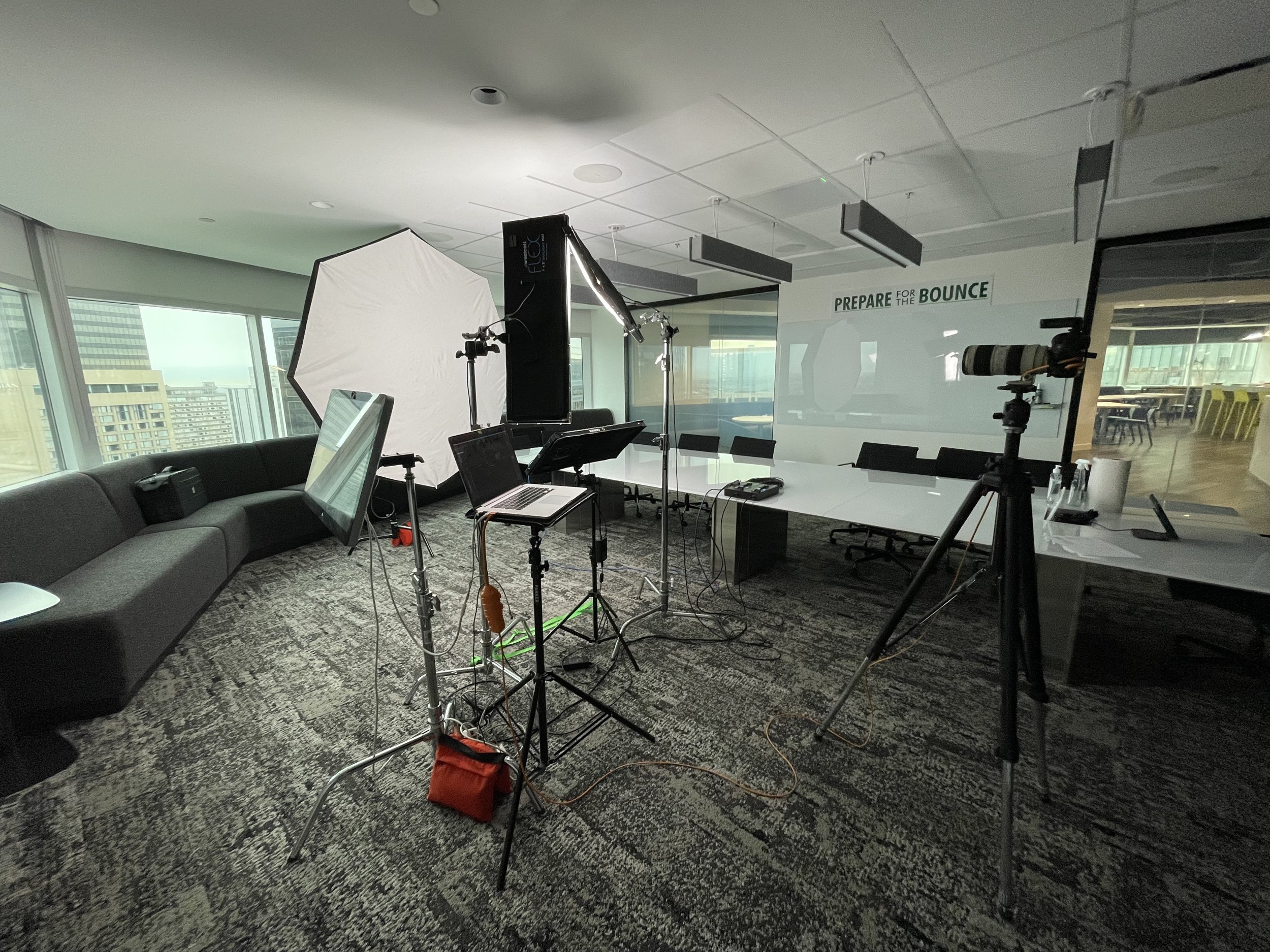 Ryan Parker’s on-location headshot setup, lights, backdrop and tethered screen, in a glass boardroom