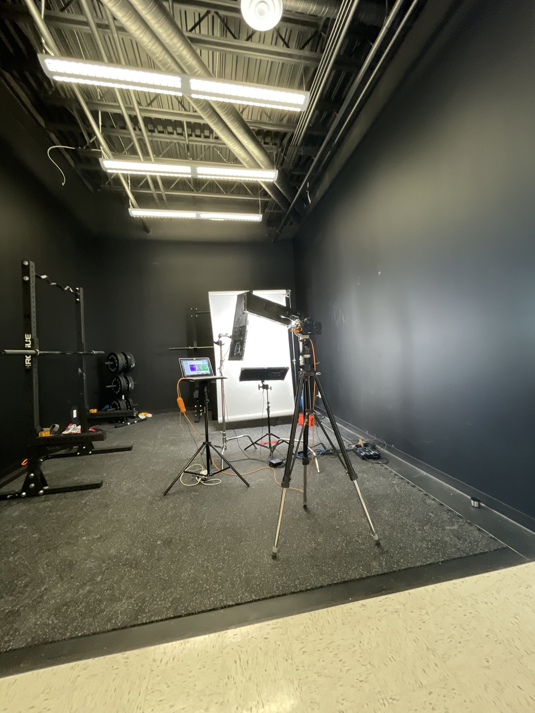 Ryan Parker’s on-location headshot setup, lights, backdrop and tethered screen, in a gym