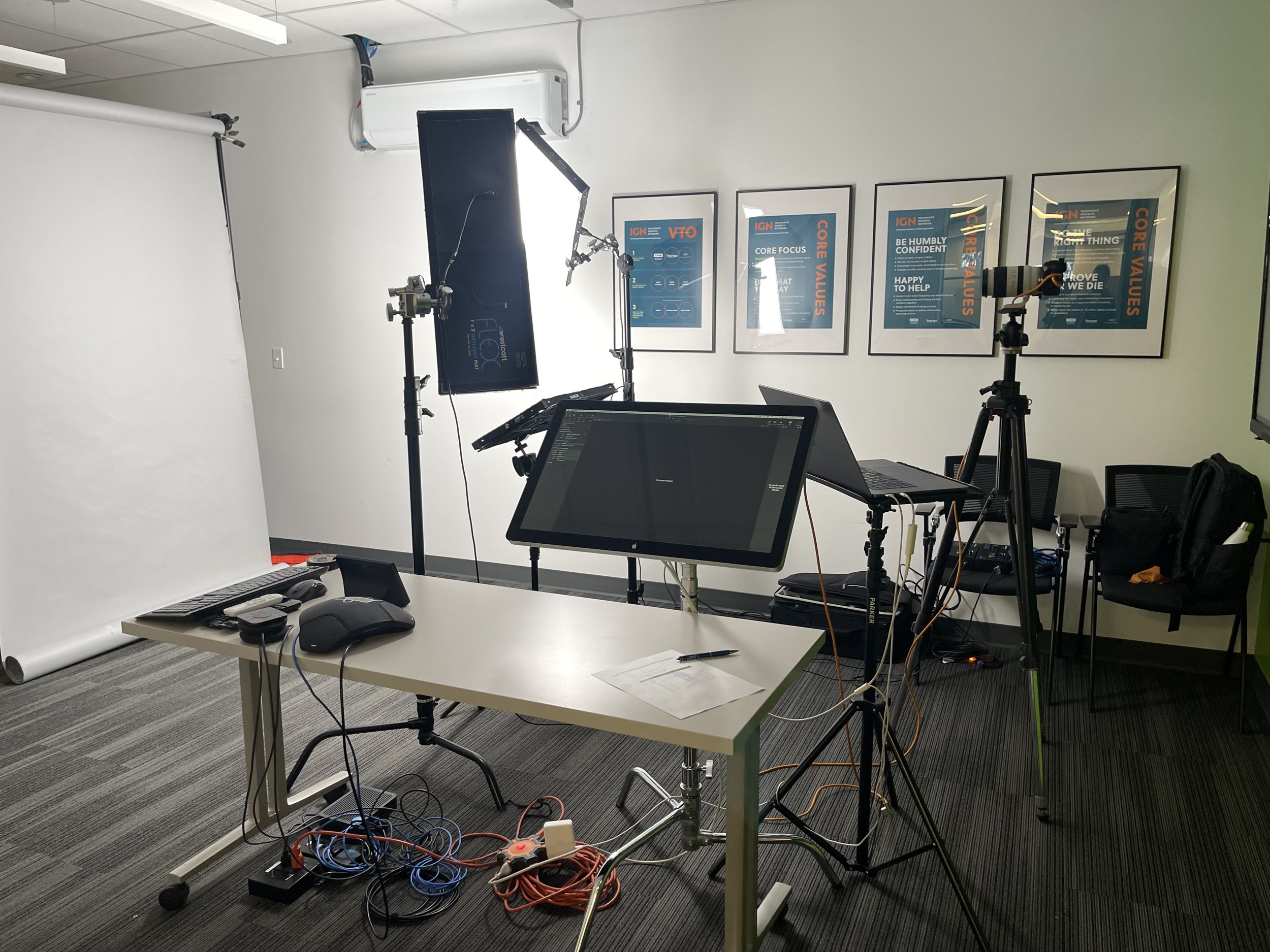 Ryan Parker’s on-location headshot setup, lights, backdrop and tethered screen, in a meeting room