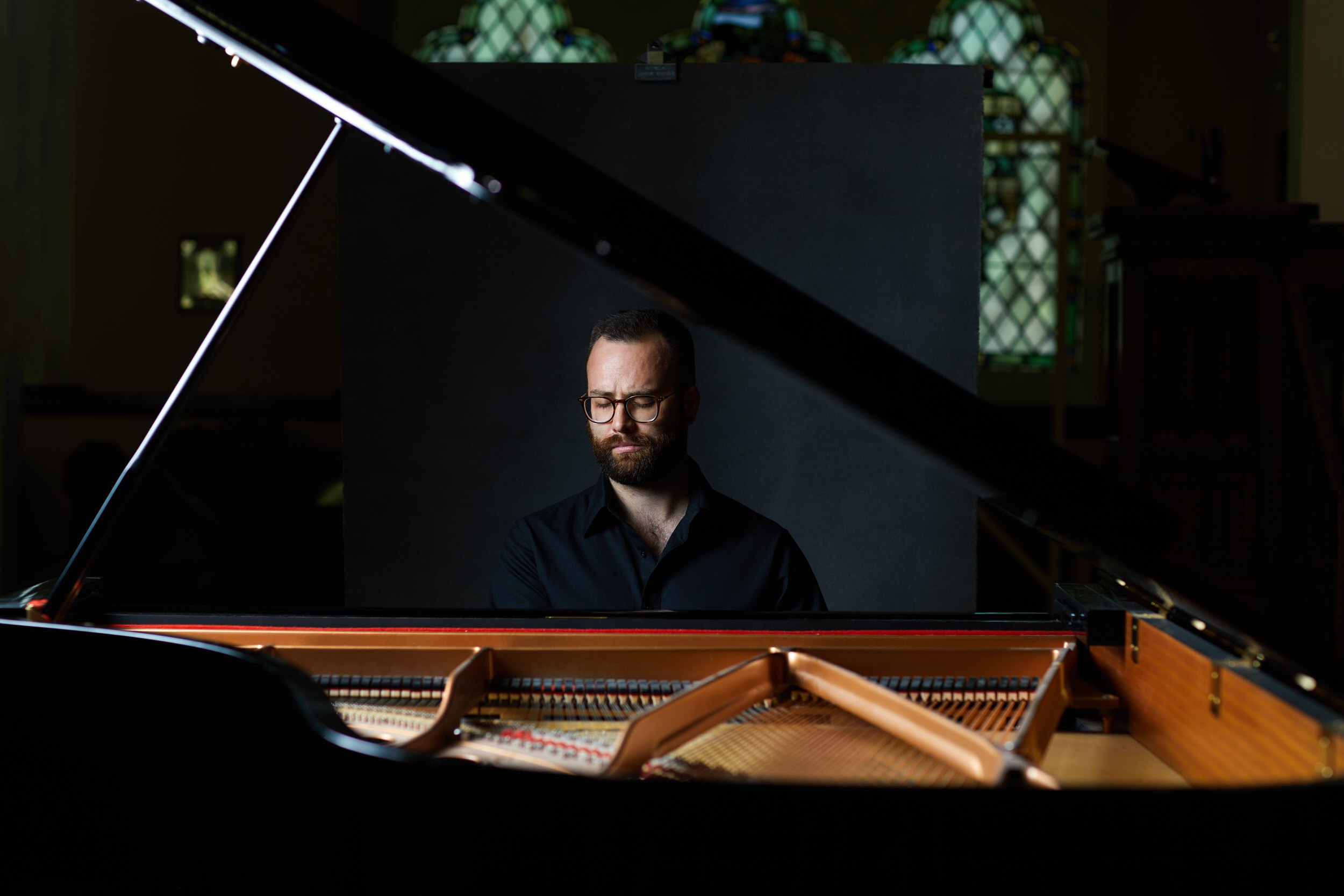 Leaning on the piano, wide