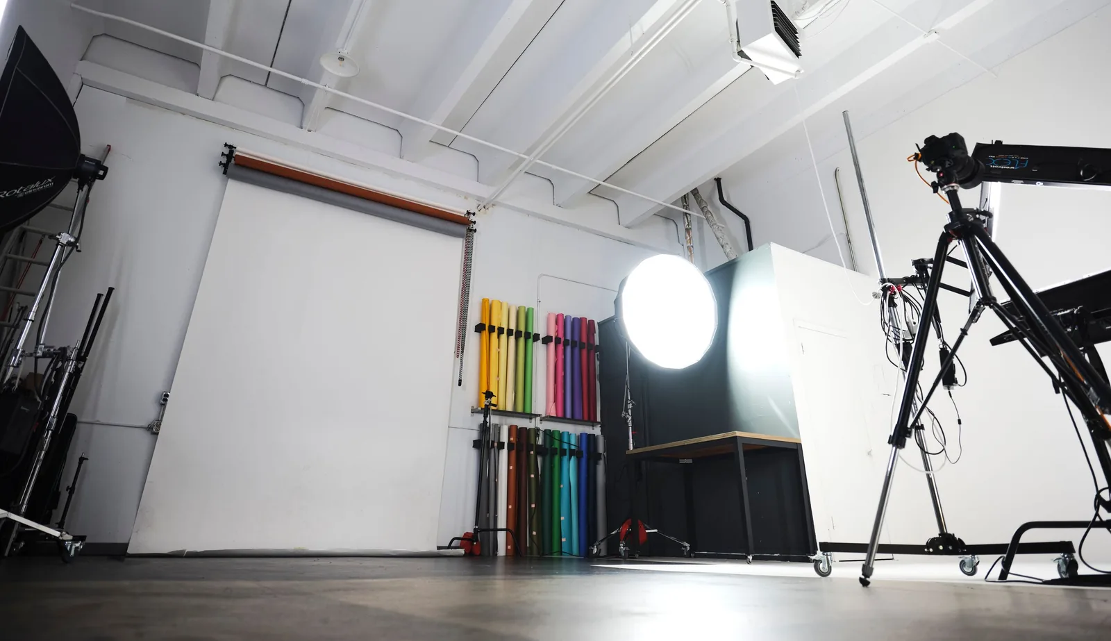 The shooting space at Ryan Parker Photography in Edmonton, with a lit octabox, stands and the wall of paper backdrops
